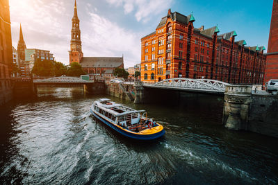 View of boats in river against buildings