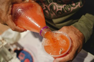 Close-up of hand holding drink