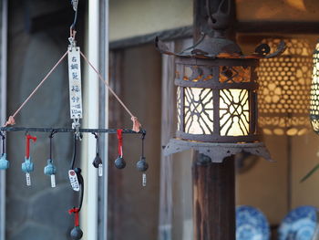 Close-up of lamp hanging on wall