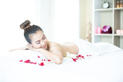 Young woman lying on bed