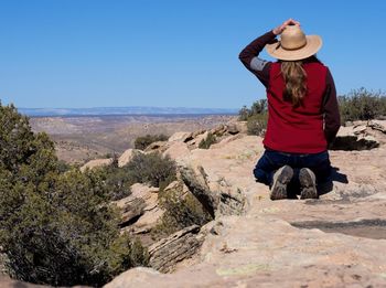 Rear view of man looking at view of landscape