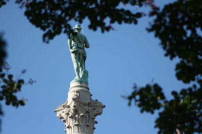 Low angle view of statue against sky