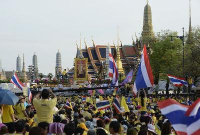 High angle view of people with thai flags at event outside temple