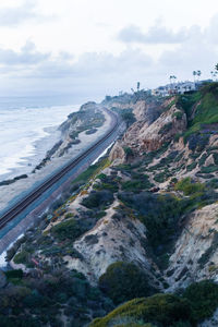 High angle view of road by land against sky