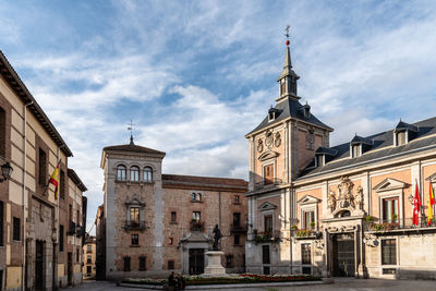 Low angle view of buildings against sky in city