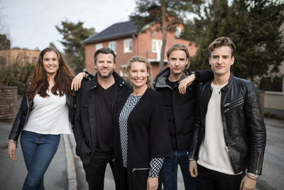 Portrait of confident family standing at yard