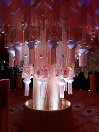 Illuminated lanterns hanging on wooden table