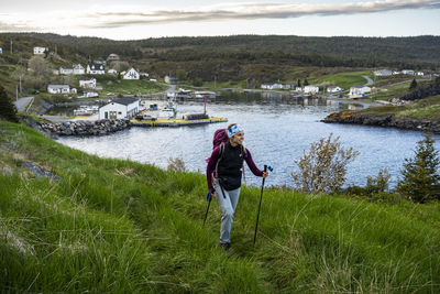 Female backpacker hiking near small town on east coast trail