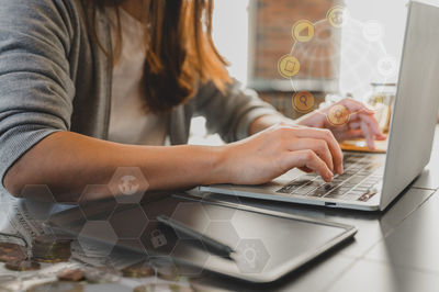 Midsection of woman using mobile phone