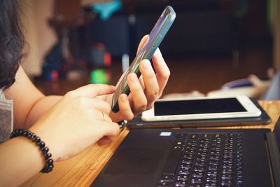 Midsection of woman using mobile phone