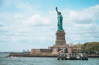 Statue of liberty against cloudy sky