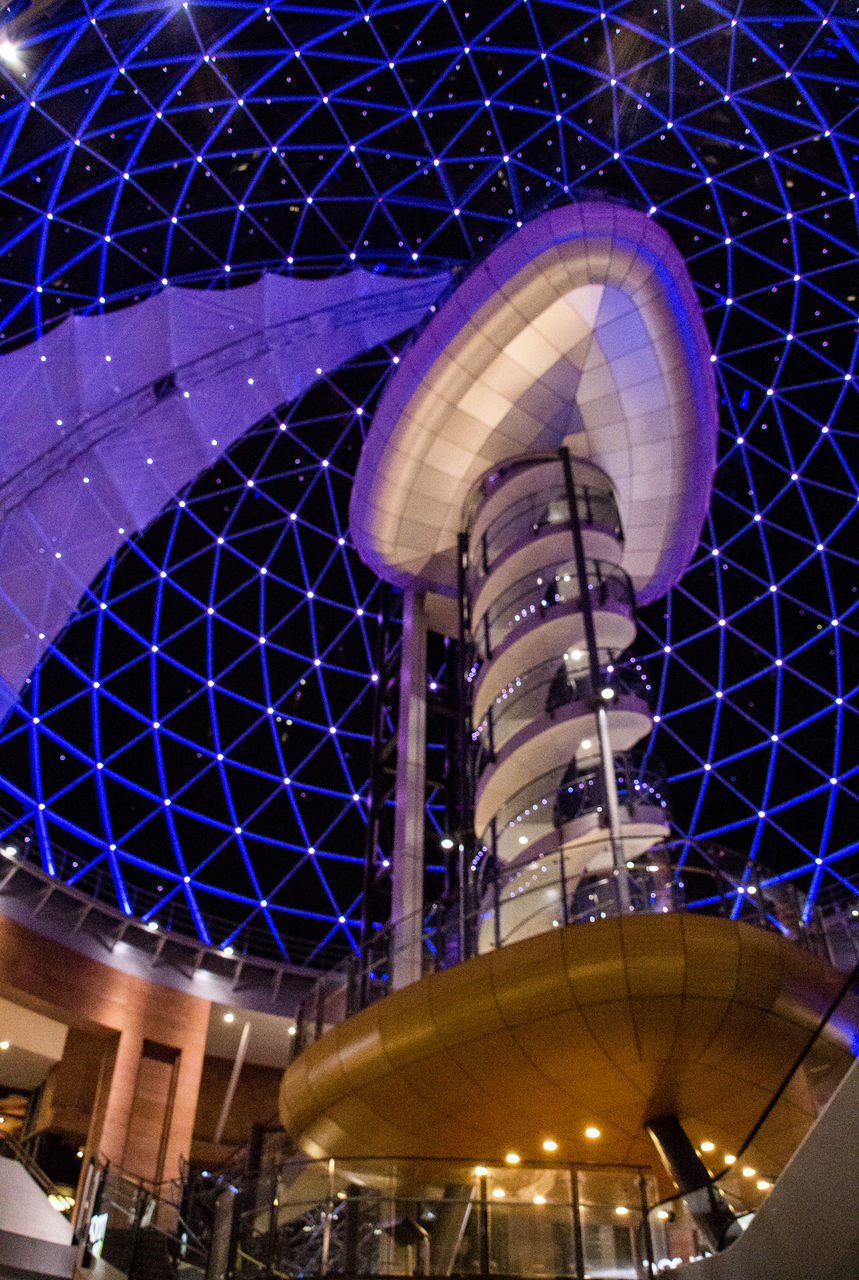 LOW ANGLE VIEW OF ILLUMINATED FERRIS WHEEL IN CITY