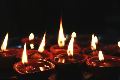 Close-up of lit candles with black background