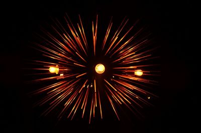 Low angle view of firework display at night
