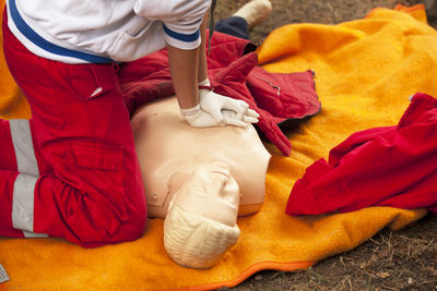 Paramedic practicing cpr on mannequin