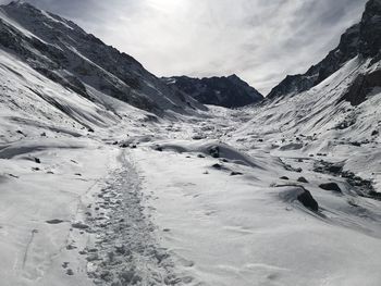 Scenic view of snow covered mountains against sky