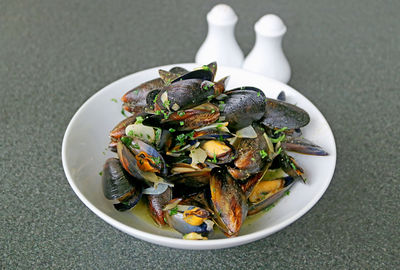 A bowl of moules mariniere or belgian steamed mussels in white wine and garlic