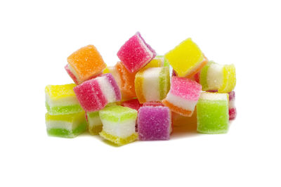 Close-up of multi colored candies against white background