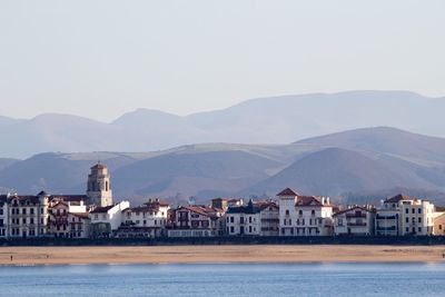 Scenic view of river and mountains against sky