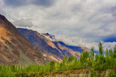 Scenic view of mountains against cloudy sky