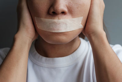 Midsection of woman covering face