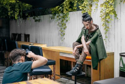 Friends looking at while sitting on table