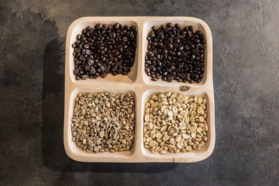 Directly above shot of various coffee beans in container on table