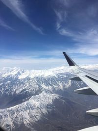 Aerial view of snowcapped mountains against sky