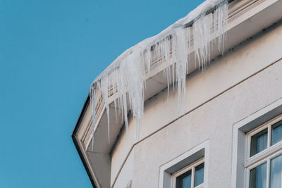 Icicles hanging from the edge of roof