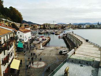 High angle view of harbor by river against sky