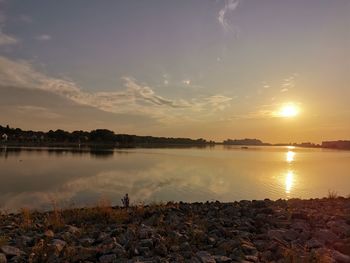 Scenic view of lake against sky during sunset