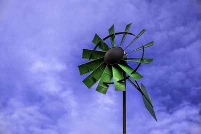 Low angle view of traditional windmill against sky