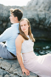 Young woman sitting on rock