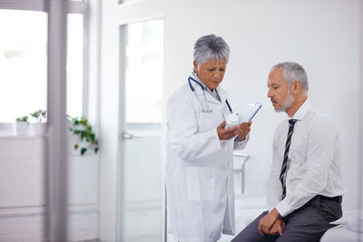 Female doctor examining patient in hospital