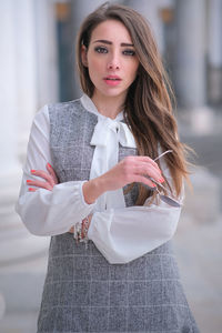 Portrait of a beautiful young woman standing outdoors