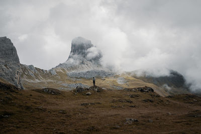 Rear view of man standing against mountain