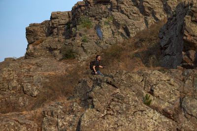 Full length of person on rock at mountain