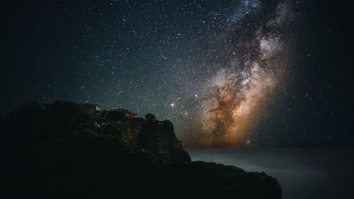 Scenic view of rocks against sky at night