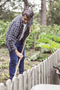 Male farmer weeding at organic farm