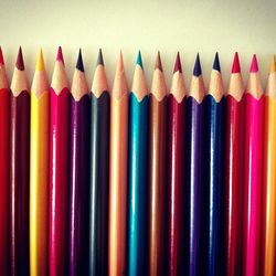 High angle view of colored pencils arranged on table