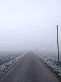 Road against sky during foggy weather
