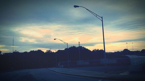 Street light against cloudy sky