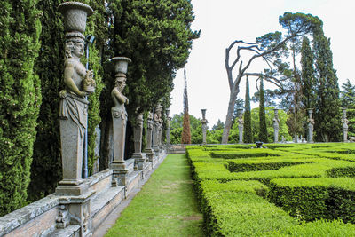 Statue amidst trees against clear sky