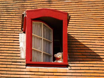 Open window of red house
