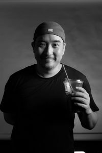 Smiling man holding a glass of water