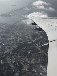 Cropped image of airplane flying over cityscape