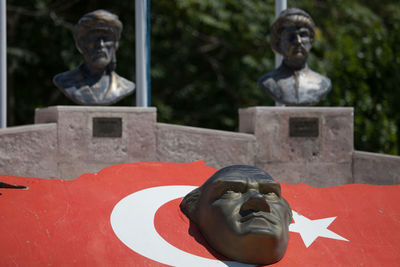 Close-up of statue on turkish flag