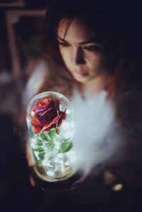 High angle view of woman holding illuminated decoration at home