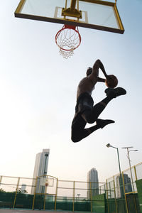 Black man playing basketball game