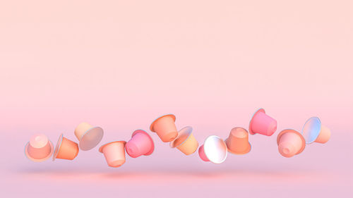 High angle view of pills against pink background